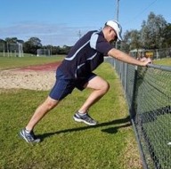 Acceleration Lean With Knee Drive Against Fence